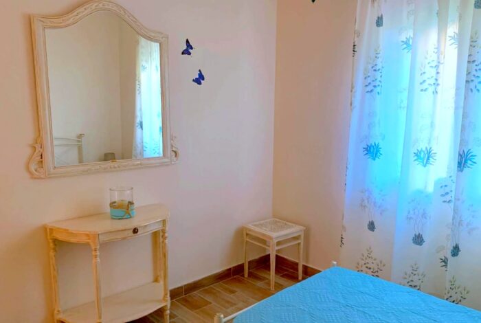 Bright bedroom with tiled floors and simple decor in Corfu property for sale