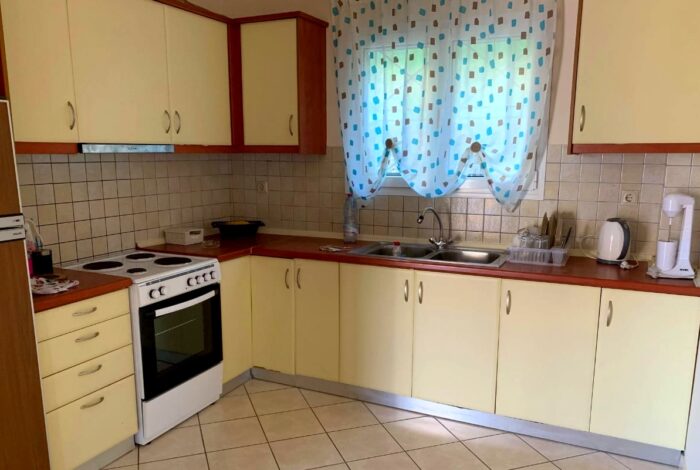 Functional kitchen space integrated with living area, ideal for everyday living in Corfu