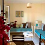 Bright living room with open-plan layout and access to front terrace in Kanalia, Corfu apartment for sale