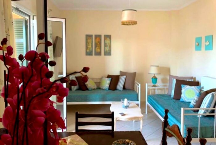 Bright living room with open-plan layout and access to front terrace in Kanalia, Corfu apartment for sale