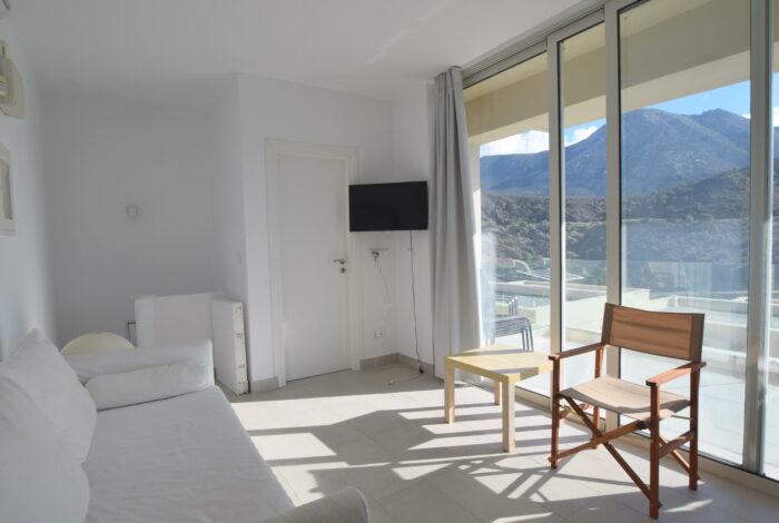 Maisonette living area with natural light and balcony access