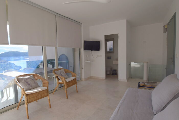 Airy living room with glass doors opening to private terrace