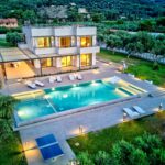 Exterior night shot of Corfu villa with 200 sqm living space and olive trees