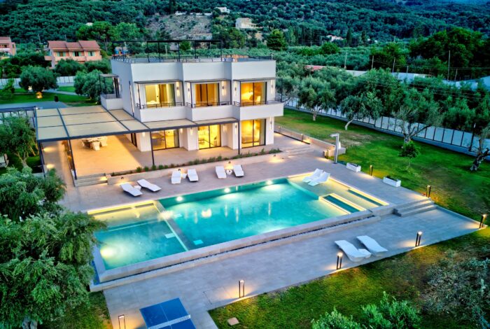 Exterior night shot of Corfu villa with 200 sqm living space and olive trees