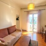 Bright living room with natural light and balcony access in Garitsa Corfu apartment