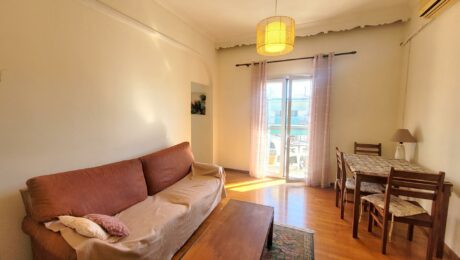 Bright living room with natural light and balcony access in Garitsa Corfu apartment