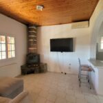 Open plan lounge kitchen with fireplace in Corfu house