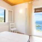 Second bedroom with balcony access and sea view