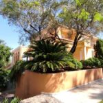 Large paved terrace surrounding infinity-style swimming pool