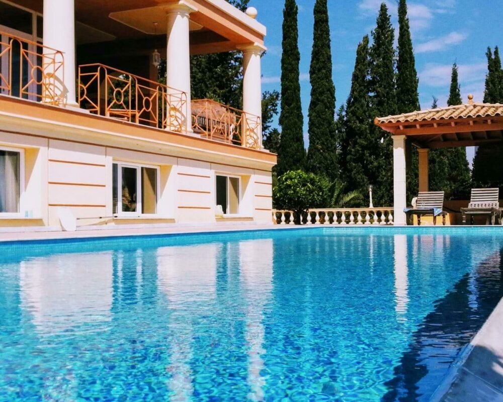 Luxury infinity swimming pool surrounded by spacious terraces