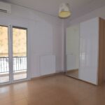 Comfortable bedroom with natural light in renovated Piraeus apartment