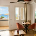 Bright living room with terrace access in renovated Corfu apartment