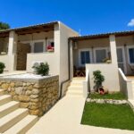 Exterior view of independent apartments in Corfu surrounded by lush greenery