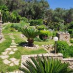 Stone pathways through landscaped gardens in Paleokastritsa property