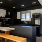 Modern kitchen with fitted cabinets and dining area in renovated maisonette