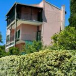 Traditional Corfu detached house exterior set on a 350 sq.m. plot surrounded by lush greenery