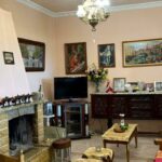 Bright and spacious living room in Corfu villa with fireplace and warm atmosphere