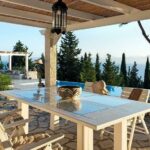 Spacious villa terrace with covered pergola overlooking the sea in Paxos
