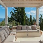Covered outdoor dining pergola with stunning coastal views in Paxos