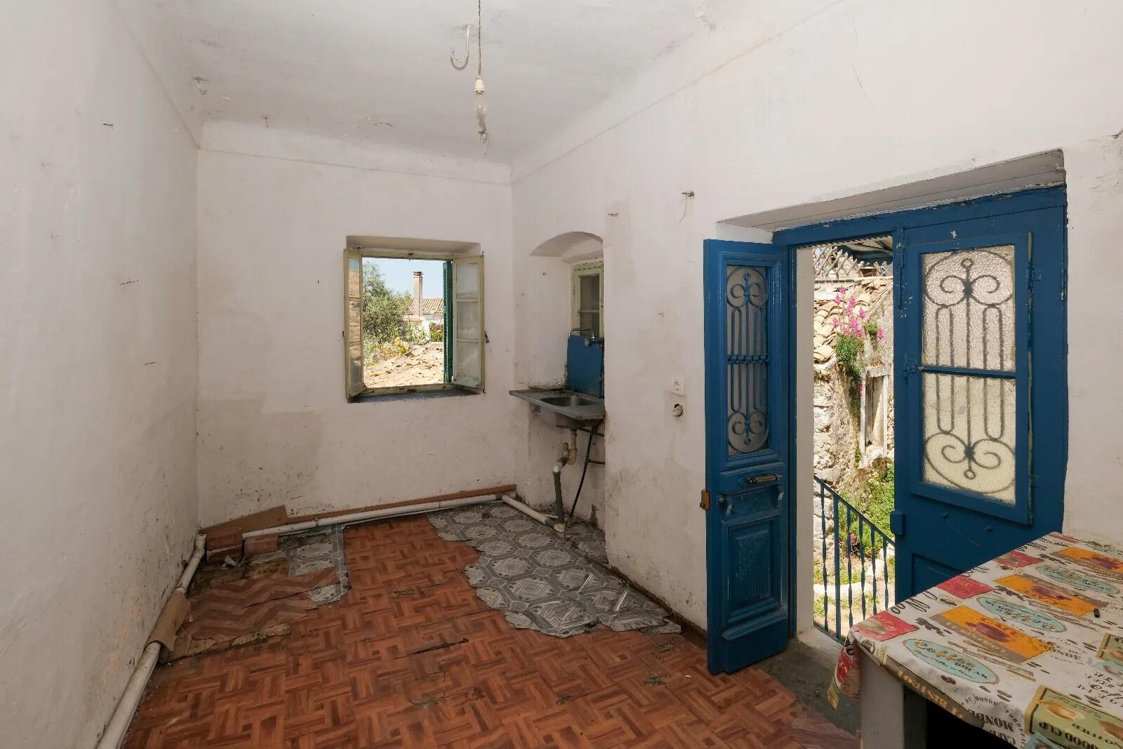 Traditional wooden doors and stone walls in heritage home in Corfu