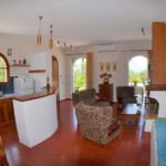 Bright living room with fireplace in Gastouri home