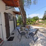 Covered paved sitting area on the ground floor apartments