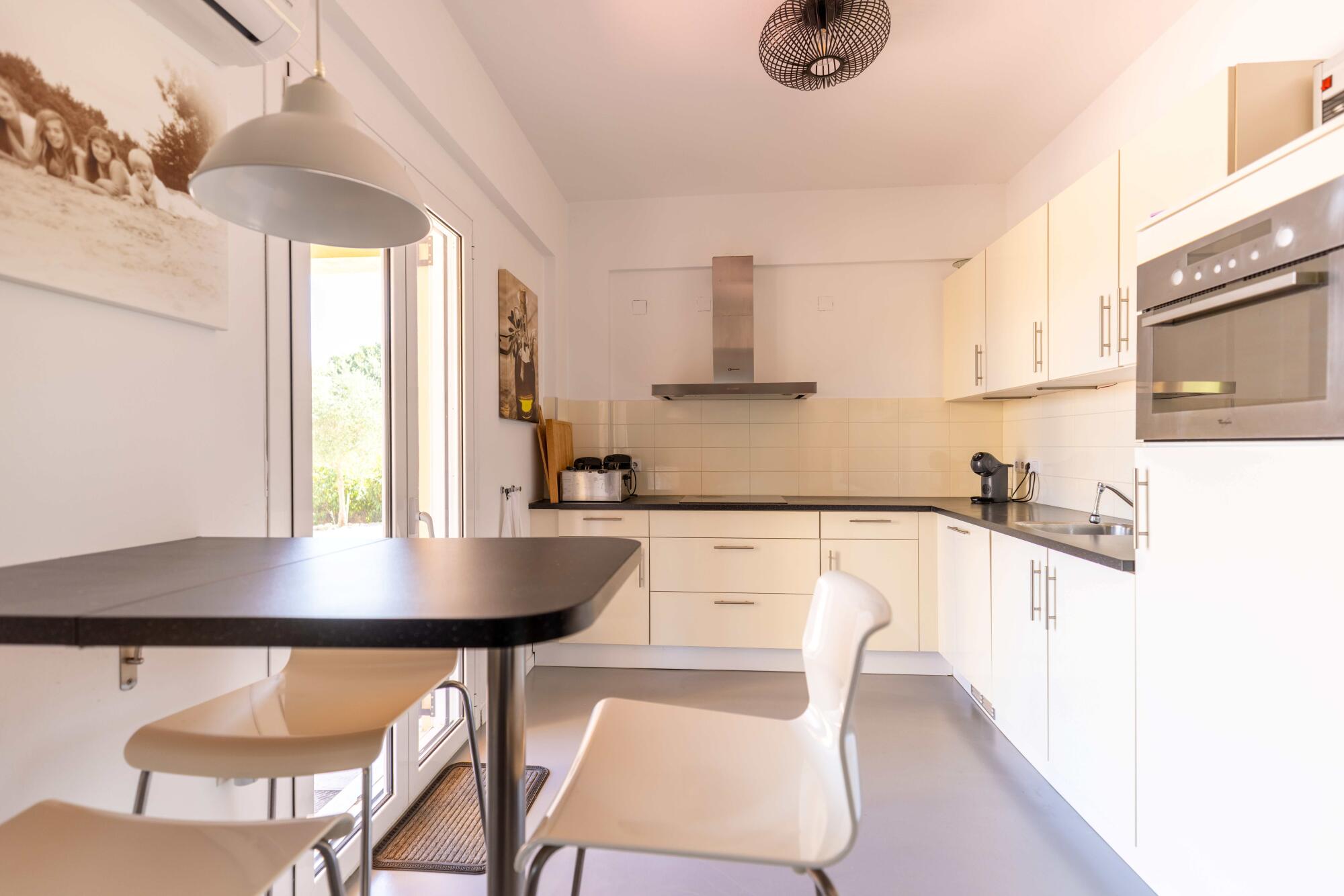 Contemporary kitchen and dining area in a Corfu countryside residence