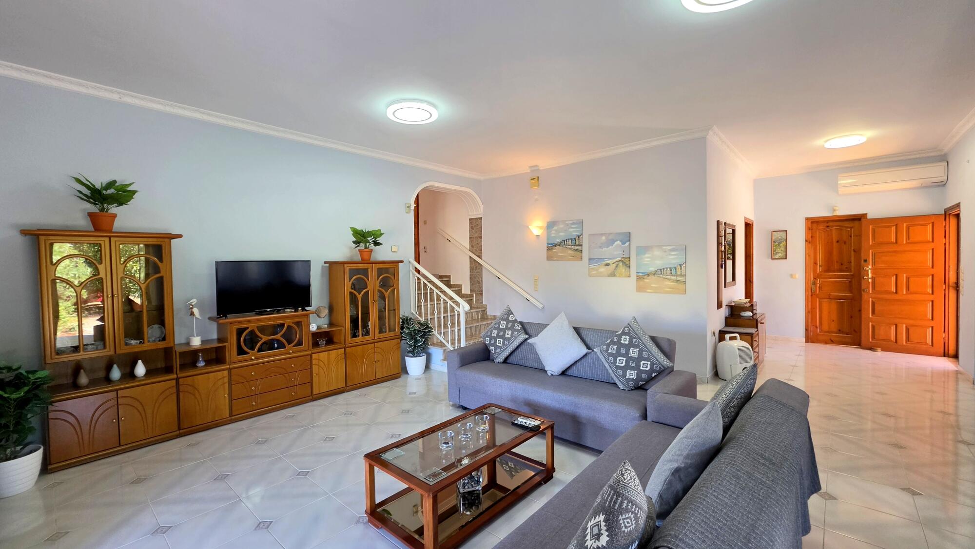 Spacious living room with dining area in Lefkimmi residence