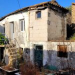 Exterior view of a traditional stone village house in Kato Pavliana