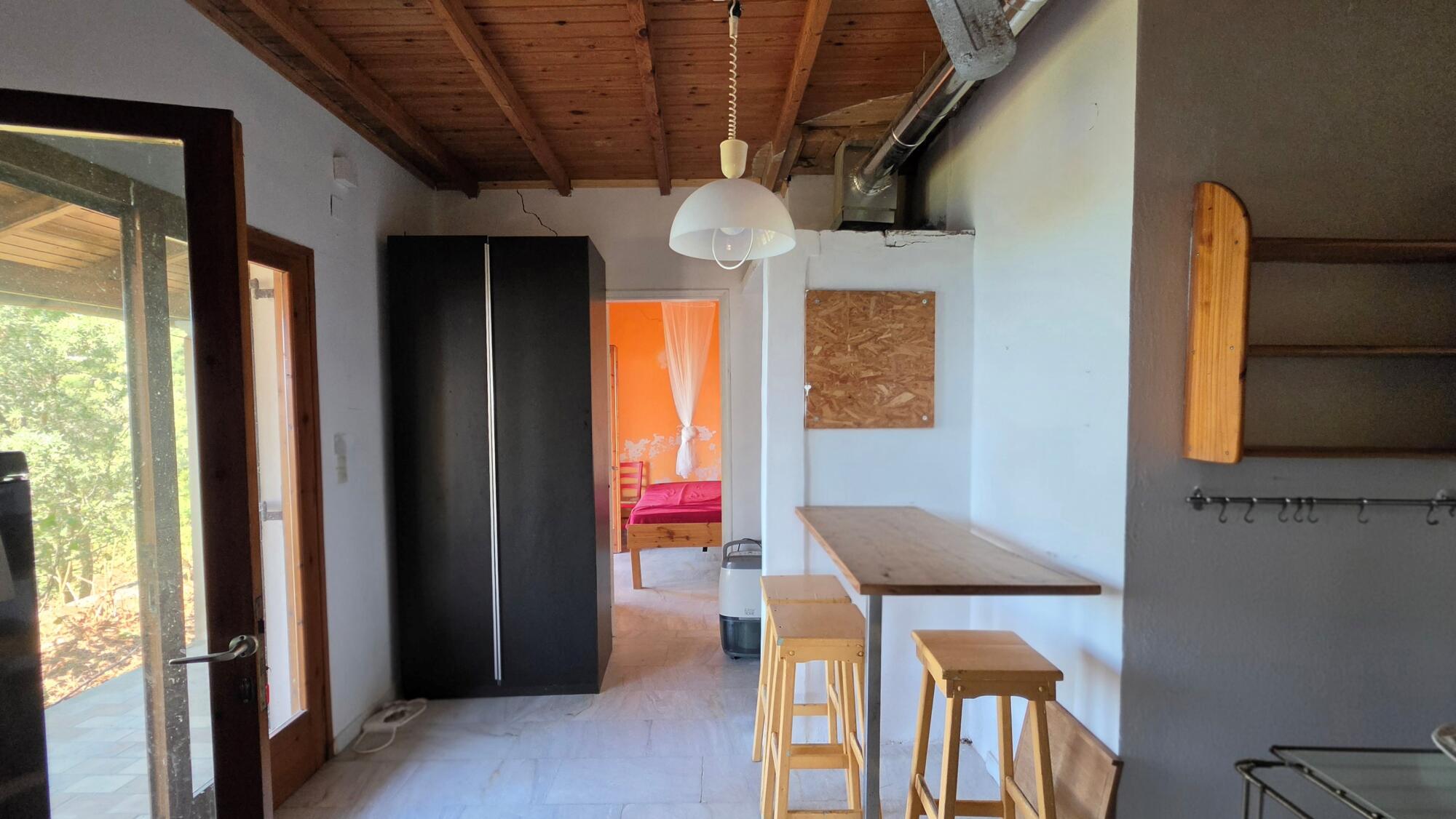 Upper house interior with access to covered terrace in Pentati