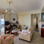 Open-plan living room and kitchen in an apartment for sale in Nissaki, Corfu