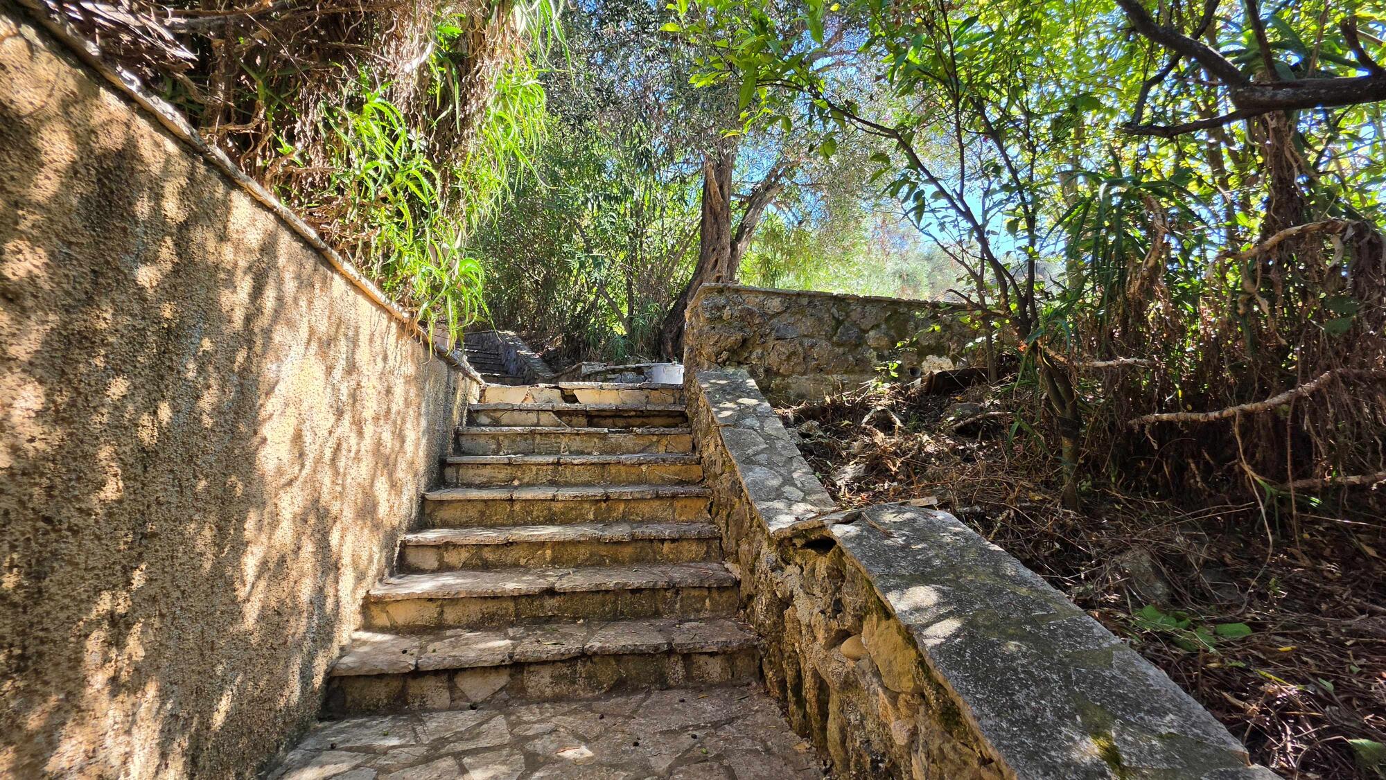 Natural stone walls and landscaped garden at Pentati seaside property