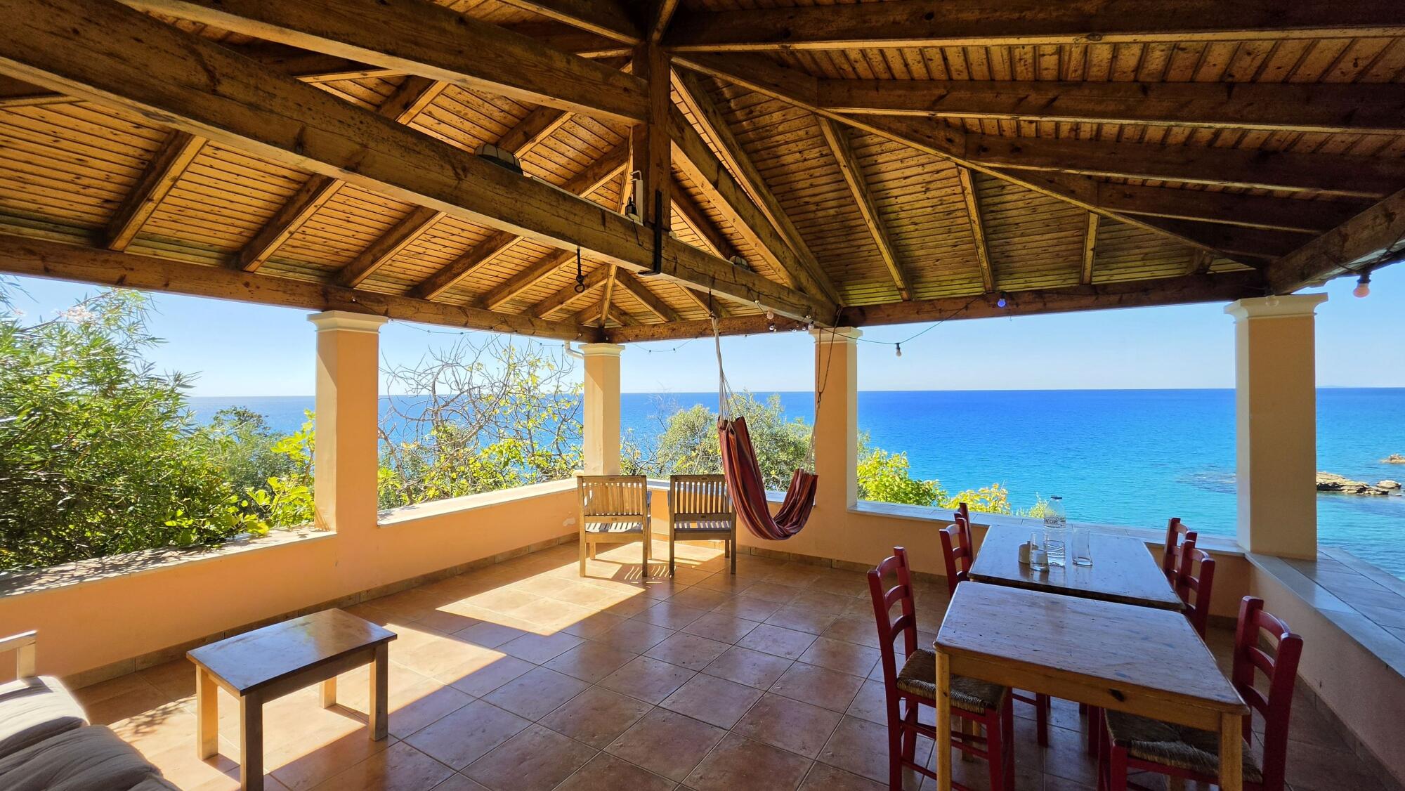 Covered terrace overlooking the Ionian Sea and sunset in Pentati Corfu